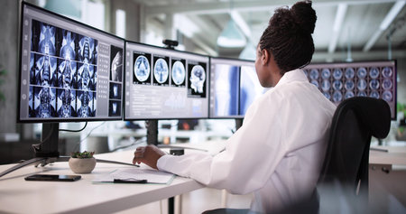 African American Doctor Using Software To Scan Imaging For Surgery.の写真素材