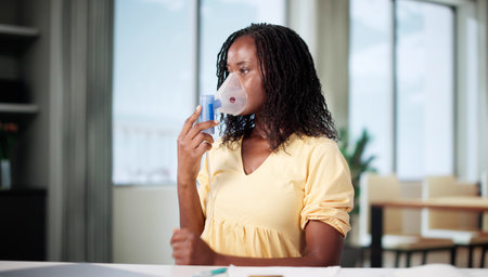 Woman With Cystic Fibrosis Using Oxygen Mask And Nebulizer At Home.