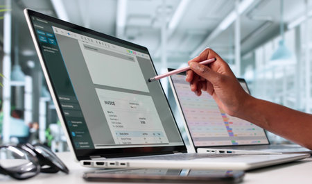 Busy Business Accountant Using E-Invoice Software On Multiple Screens