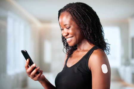 African Woman Monitors Glucose Levels On Smartphone With Diabetic Sensor.