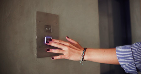 Female Engineer Operating Elevator Panel, Engaging Building Technology & Accessの写真素材