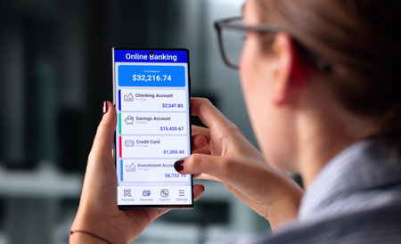 Woman Using Mobile App For Online Banking Balance Transactions Check.の写真素材