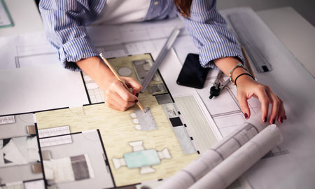 Female Architect Designing CCTV Security System With Alarm Camera Planの写真素材