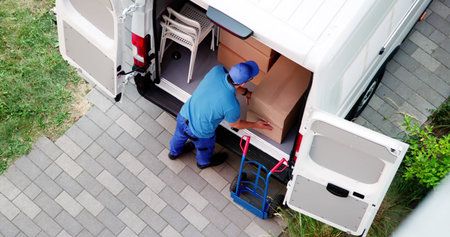 Busy Movers Unloading Mattresses From Furniture Delivery Truck In Cityの写真素材