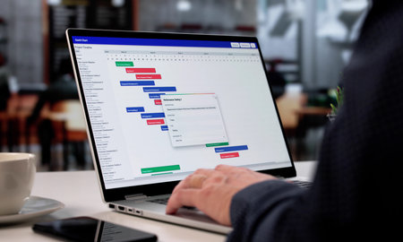 Man In Cafe Using Efficient Schedule Management Software On Laptop