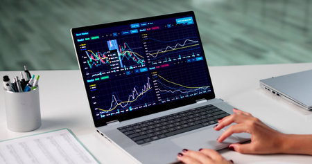 Young Female Broker Analyzing Stock Market Data On Computer In Office.
