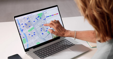 Woman Searches Online For Real Estate Properties On Her Computer. Senior Woman Uses Laptop To Locate...