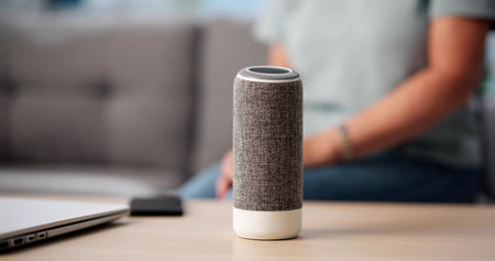 Senior Woman Sitting Alone, Listening To Music On Smart Speakerの写真素材