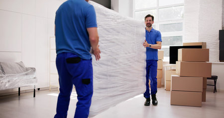 Professional Movers Relocating A Mattress Into A New Bedroom Home.の写真素材