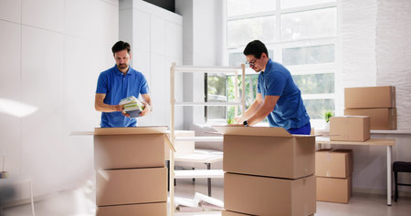 Skilled Movers Expertly Packing Furniture To Move Into New House.の写真素材