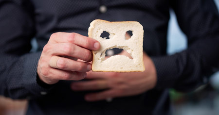 Young Man Refuses Gluten Bread, Shows Sadness Over Celiac Disease.の写真素材