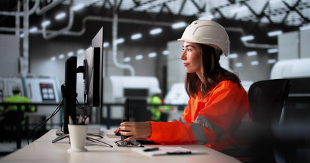 Factory Worker Communicating With Walkie-Talkie In Industrial Production Facility.