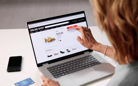 Senior Woman Shopping Online For Shoes At An Ecommerce Store.の写真素材