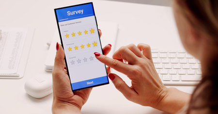 Person Completing Mobile Survey For Business Feedback, Quality Analyst Professionの写真素材