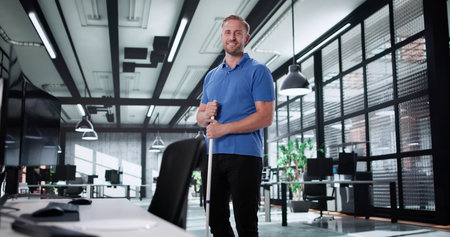 Happy Professional Office Cleaner Posing Beside Desk After A Long Day.の写真素材