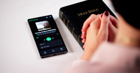 Christian Woman Engrossed In Bible Study, Listening To Worship Audiobookの写真素材