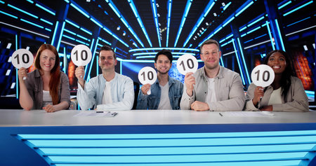 Happy Judges Sitting With Scorecards Showing Panel Recruiting 10 Signsの写真素材