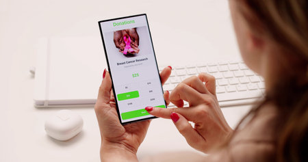 Young Woman Contributes To Nonprofit Fundraiser Using Mobile Donation App.の写真素材
