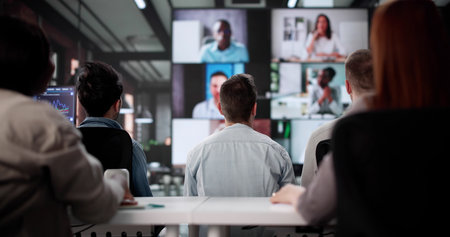 Professional Team Conducting Distance Business Video Conference In Office Room