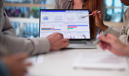 Multicultural Team Analyzing Demographic Data For Financial Predictions In Office