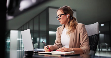 Virtual Office Chat: Woman Attending Online Webinar With Computer Audioの写真素材