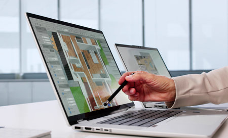 Elderly Woman Using Virtual Design Software To Remodel Real Estateの写真素材