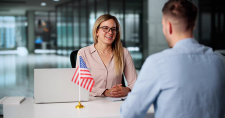 Consultant Assists Young Couple With US Immigration Visa Application Processの写真素材