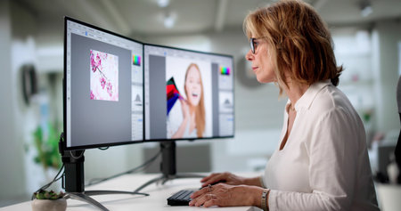 Elderly Graphic Designer Works Late From Home On Colorful Projectsの写真素材