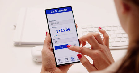The Young Woman Is Checking Her Mobile Banking Account Onlineの写真素材