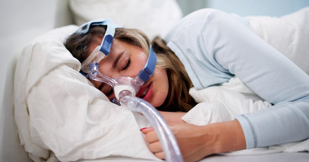 The Woman Wearing A Sleep Apnea Oxygen Mask Is Resting.の写真素材