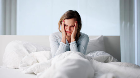 Exhausted Nurse With Migraine Wakes Early In Cluttered Hospital Room.の写真素材