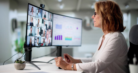Woman Holding Video Conference Call With Remote Workers From Home.の写真素材
