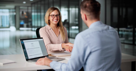 HR Consultant Shaking Hands With Customer Service Staff During Interviewの写真素材