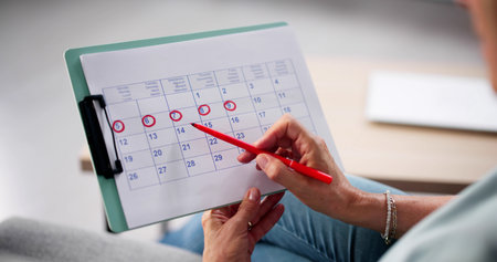 Monthly Schedule: Woman Using Menstrual Cycle Calendar For Pain Controlの写真素材