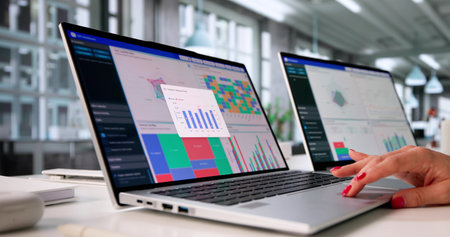 Female Analyst Evaluating Market Trends On Computer In Modern Office.