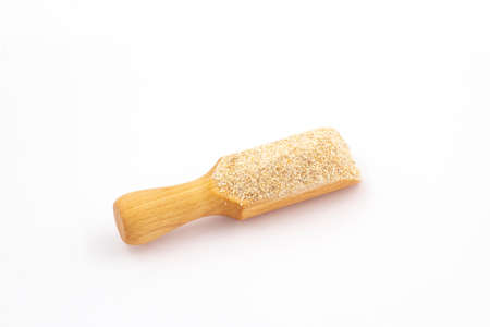 Scoop with ground grits on a white backgroundの写真素材