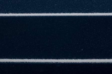 Dark blue background for with snow stripes of snow for design.