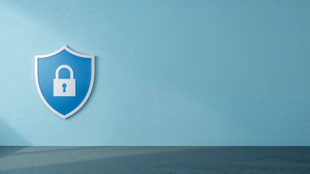 Image features a minimalist and modern style, depicting a large shield emblem on the left side of the frame. The shield is predominantly blue with a white border, and prominently displays a white padlock icon in the center, symbolizing security and protection. The background is a smooth, gradient light blue wall, creating a clean and professional atmosphere. The floor is a dark gray, adding contrast to the overall composition. The layout is simple, with the shield slightly off-center, drawing attention to the security theme without any additional text or logos present.の素材
