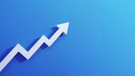 Image is a digital graphic featuring a minimalist design with a blue gradient background. Dominating the left side is a bold, white zigzag arrow pointing upwards, symbolizing growth or progress. The arrow casts a subtle shadow to the right, adding a sense of depth to the otherwise flat design. The overall composition is clean and modern, with the arrow's sharp angles contrasting against the smooth gradient of the background. There are no people, text, or logos present in the image, emphasizing the simplicity and clarity of the visual message.の素材