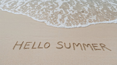 Image is a landscape-style photograph capturing a sandy beach with gentle ocean waves lapping at the shore. The sand is light beige, and the water is a soft blue with white foam. In the foreground, the words 'HELLO SUMMER' are written in the sand in uppercase letters. The text appears to be hand-drawn, with slightly uneven lines, giving it a casual and playful appearance. The overall composition conveys a relaxed and inviting summer atmosphere, with the contrast between the smooth sand and the textured water adding visual interest.の素材