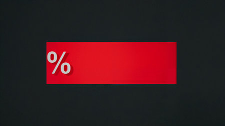 Image is a digital graphic featuring a bold, minimalist design. It consists of a large, horizontal red rectangle set against a dark gray background. On the left side of the rectangle, there is a prominent white percentage symbol ('%') in a modern, sans-serif font. The percentage symbol is three-dimensional, casting a subtle shadow on the red rectangle, adding depth to the design. The red rectangle occupies the majority of the image, creating a strong contrast with the dark gray background and the white symbol. The overall composition is clean and striking, with a focus on the color contrast and the simplicity of the elements.の素材