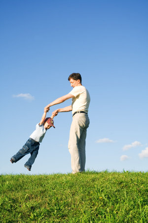 Young boy played with father. Green grass. Blue sky. 7の写真素材