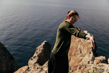 girl in blouse dancing next to the lakeの写真素材