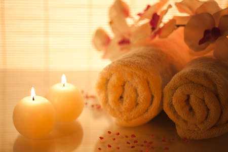 Spa towels, candle and orchid on bamboo. Focus On Foreground.の写真素材