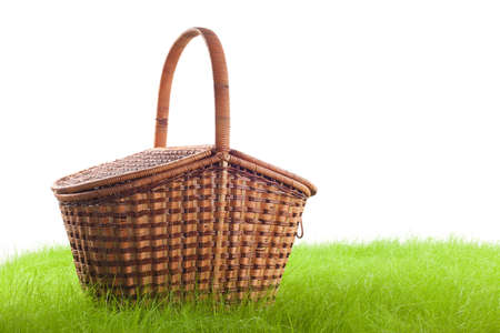 Picnic basket on the grass, isolated on white の写真素材
