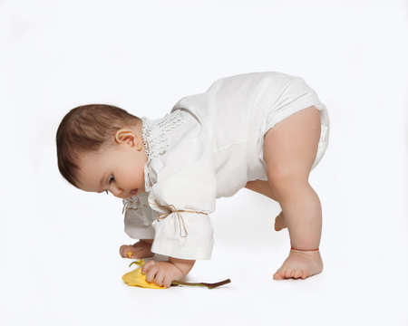 toddler learning to walk isolated on whiteの写真素材