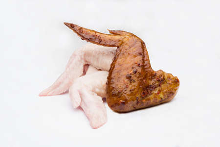 fried and raw chickens on white backgroundの写真素材