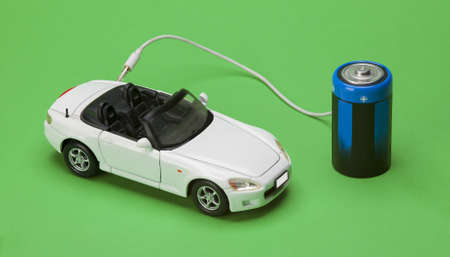 the eco car powered by batteries on green background