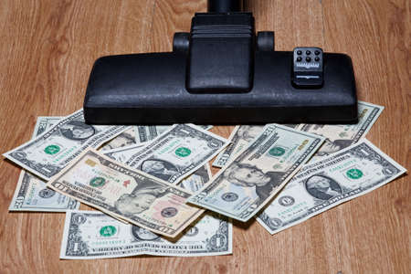 american dollars sucked with vacuum cleanerの写真素材