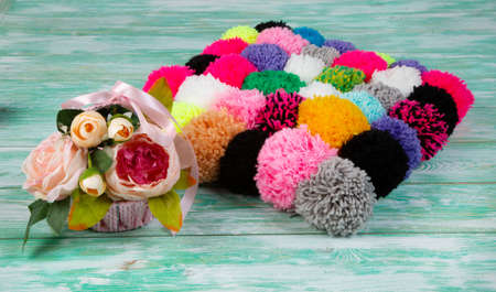 multicolored pompoms on a green background